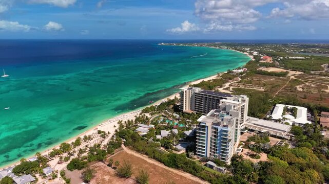 Seven Mile Beach, Cayman Islands: Aerial drone view of Grand Cayman Island with turquoise water, white sandy shoreline, luxury resorts, and tropical coastline - landscape panorama of Caribbean Sea

