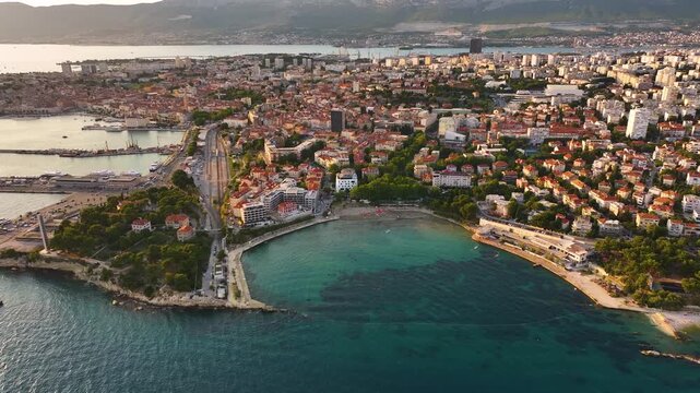 View of Split Croatia from above showing coastline, city layout, and surrounding mountains during daytime