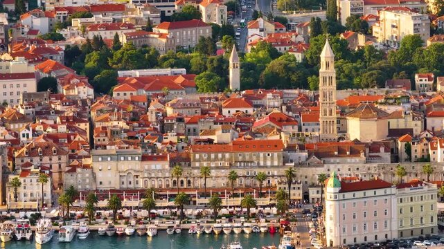 Historic buildings and waterfront in Split Croatia with red rooftops and green trees