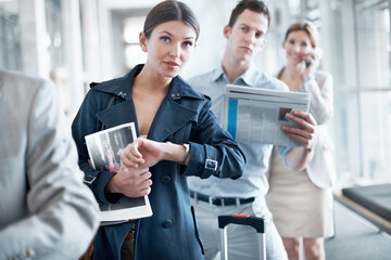 Obraz premium Woman, airport and time in queue for travel delay, business trip and global journey with group. People, international flight or person with watch, schedule or waiting in line with late passenger