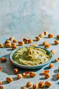 a bowl of pistachio cream among pistachios