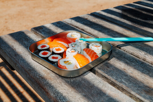 a tray of sushi in bright sunlight