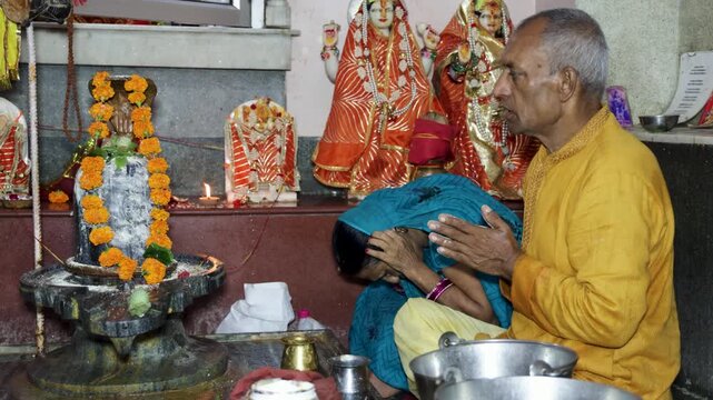 Devotees Offering Holy Prayers To Shiva Lingam During Hindu Temple Worship Ceremony