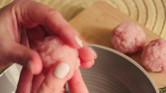 Close-up of housewife hands shaping raw meat cutlets from minced meat. Homemade cooking process and meal preparation in the kitchen. High quality 4k footage