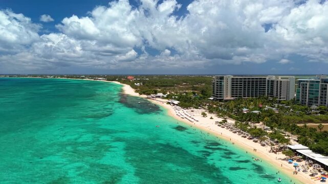 Seven Mile Beach, Cayman Islands: Aerial drone view of Grand Cayman Island with turquoise water, white sandy shoreline, luxury resorts, and tropical coastline - landscape panorama of Caribbean Sea
