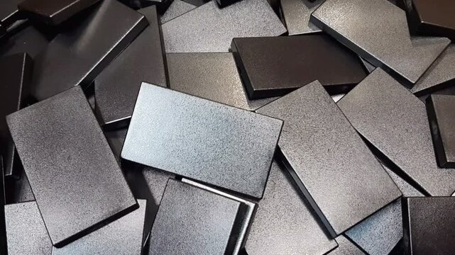 Static macro video of industrial plastic parts background. Stack of manufactured components, polymer textures and factory production concept. 