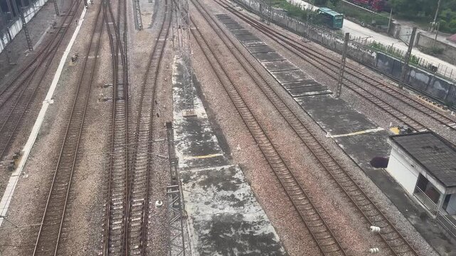 Aerial view of railway tracks at train station. Industrial transportation infrastructure with multiple parallel rails. Logistics and urban transit system for passenger and cargo travel.