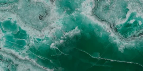 Elegant emerald green onyx marble texture with translucent layers and natural stone veins. © Vidal
