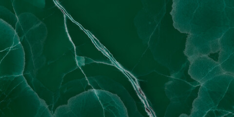 Elegant emerald green onyx marble texture with translucent layers and natural stone veins. © Vidal