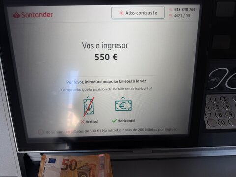 Mallorca, spain, june 27, 2026, santander atm screen displaying 550 euros deposit, banking transaction, financial technology, and cash management