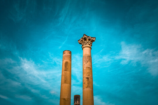 stone pillars standing tall in malta, valletta with sunny clear blue skies overhead in summer old ancient stone material columns