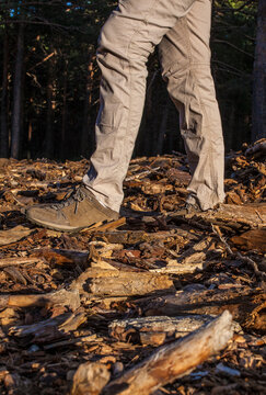 Woman walking over forest ground with accumulation of combustible material