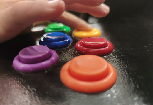 Child boy gamer pressing 6-button arcade controller