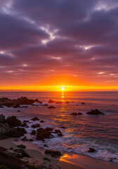 Naklejka premium Dramatic ocean sunset over rocky coastline, vibrant orange horizon with purple clouds, scenic coastal landscape at dusk, tranquil beach waves and sea rocks
