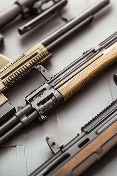 A collection of firearms arranged on a flat surface vertical frame