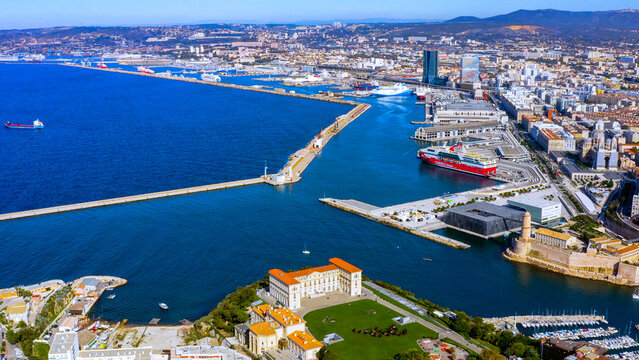 Aerial view of Marseille harbour entrance with docked passenger ferry, Palais du Pharo, Fort Saint-Jean, MuCEM and cathedral, Provence, France