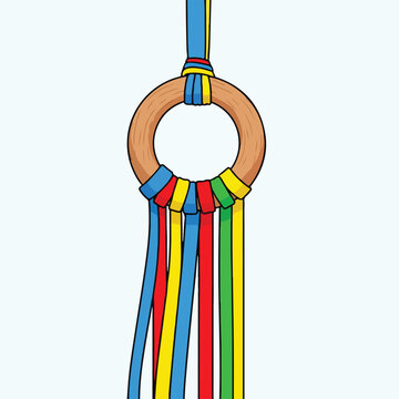 Wooden hoop with colorful hanging ribbons on a light blue background