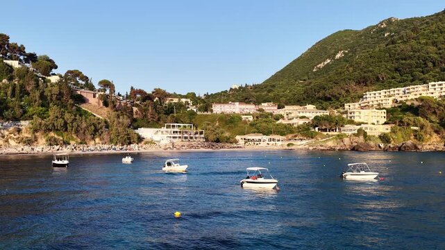 Boats anchored in Ermones Bay Corfu Greece on a clear day