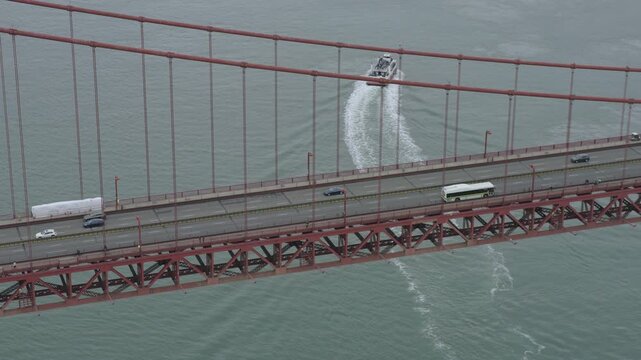 Passenger Ferry Turning Beneath Golden Gate Bridge With Traffic - Aerial Shot