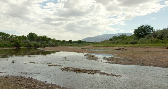 steady shot of the rio grande river drying up.