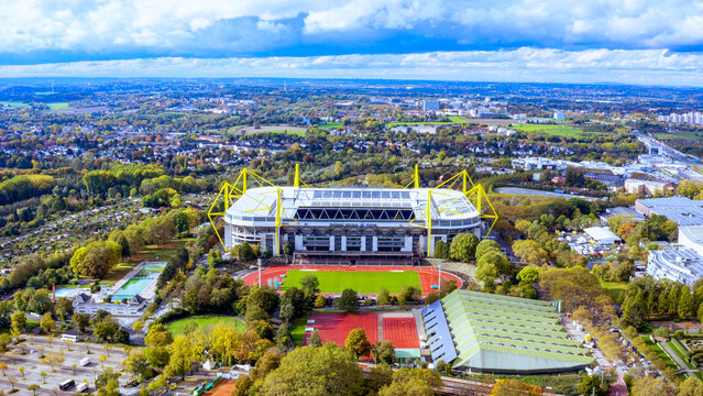 Aerial view of Signal Iduna Park football stadium with yellow pylons and the Rote Erde athletics stadium in Dortmund, Germany