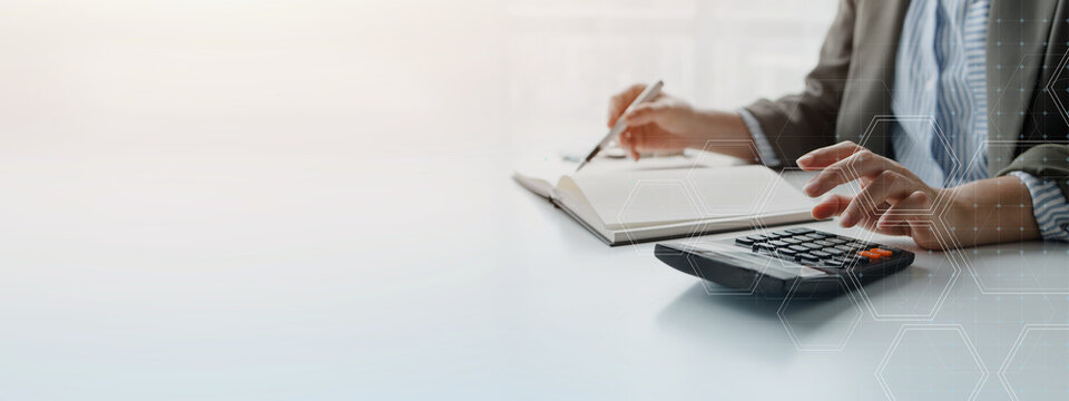 Business professional reviewing financial documents with a calculator, representing budgeting, accounting, financial planning, business analysis, and corporate decision making.
