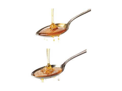 Two silver spoons with honey pouring and dripping on white background