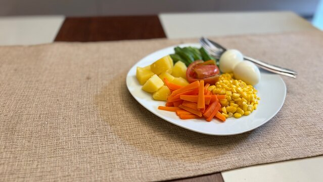 Delicious vegetable salad on white plate. Close up shot