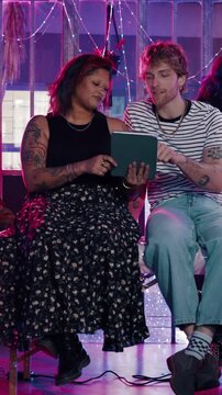 Artist, woman or consultation on tablet in tattoo shop for design review, online reference or chat. Small business, man and client with tech for creative planning, ink style decision and discussion