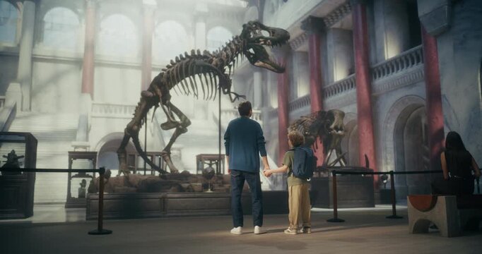 Natural History Museum Visit With Father and Young Son Watching a Giant T-rex Dinosaur Skeleton Exhibit. Family Spending Time together, Learning About Paleontology, Exploring Prehistoric Fossils