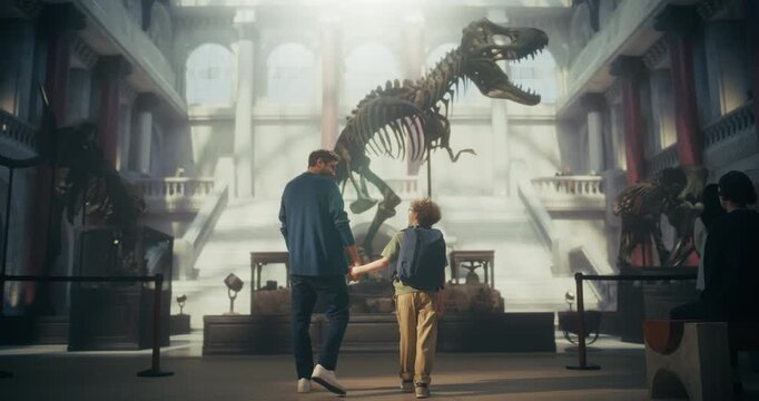 Natural History Museum Visit With Father and Son Holding Hands, Watching a Massive T-rex Dinosaur Skeleton, Learning About Ancient Prehistoric Fossils Together in a Bright Grand Exhibition Hall.