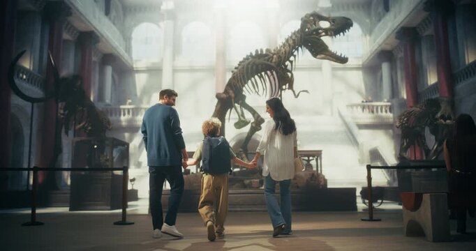Natural History Museum Visit as Father, Mother and Son Hold Hands, Walking Together to Watch a Dinosaur Skeleton. Learning Scientific Facts about Fossils While Having Fun as Family