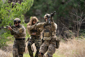 Fototapeta premium Team of military soldier army force having engage and rescue mission in dangerous battlefield for actual field operation, peace and conflict resolution