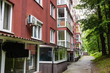 Exterior view of a modern apartment building with balconies, windows and landscaped surroundings. Residential architecture captured from street level, suitable for concepts of housing, urban © Александра Алероева