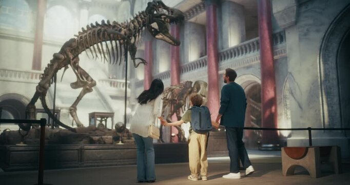 Natural History Museum Adventure: Parents and Their Young Son Look up at a Massive Dinosaur Skeleton, Watching, Discovering and Learning About Prehistoric Fossils During a Fun Family Trip.