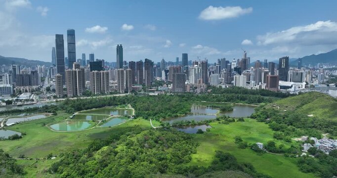Rural green fields with fish ponds between Hong Kong and skylines of Shenzhen, China	