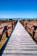 Fototapeta premium Vertical photo wooden entrance to Los Lances Beach in Tarifa, Costa de la Luz, Spain.