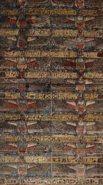 The temple of Esna, dedicated to the god Khnum. Egypt. Esna temple hypostyle hall with massive painted columns and colorful hieroglyphic reliefs on ceiling in Egypt, ancient Roman-era architecture wit
