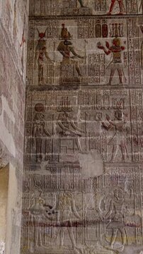 The temple of Esna, dedicated to the god Khnum. Egypt. Esna temple hypostyle hall with massive painted columns and colorful hieroglyphic reliefs on ceiling in Egypt, ancient Roman-era architecture wit