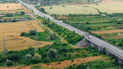 Naklejka premium Elevated highway bridge with cars crossing rural landscape