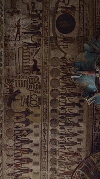 The temple of Esna, dedicated to the god Khnum. Egypt. Esna temple hypostyle hall with massive painted columns and colorful hieroglyphic reliefs on ceiling in Egypt, ancient Roman-era architecture wit