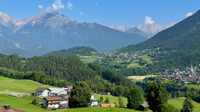 Austrian Alpine Summer Landscape with Rolling Hills and Tiny Villages