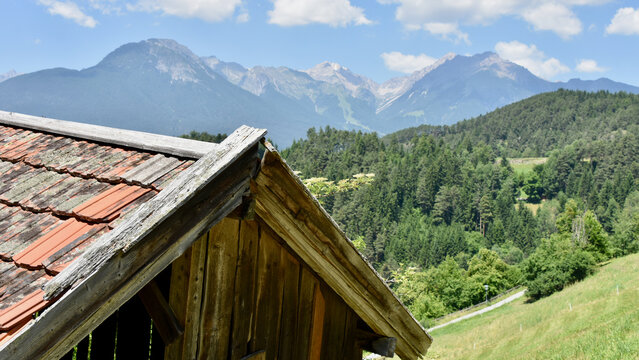 Austrian Alpine Landscape in Summer with Rustic Barn Foreground Detail