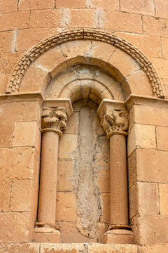 Detail of the 12th-century Romanesque apse window with checkerboard molding archivolt and carved capitals depicting birds and leaves at the Church of the Nativity of Our Lady in Sotillo, Segovia,Spain