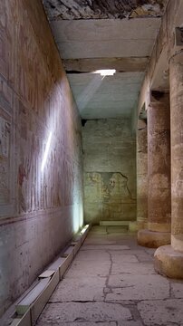 Sacred corridor inside the Abydos Temple illuminated by natural light, revealing detailed carvings and timeless Egyptian heritage. Egypt