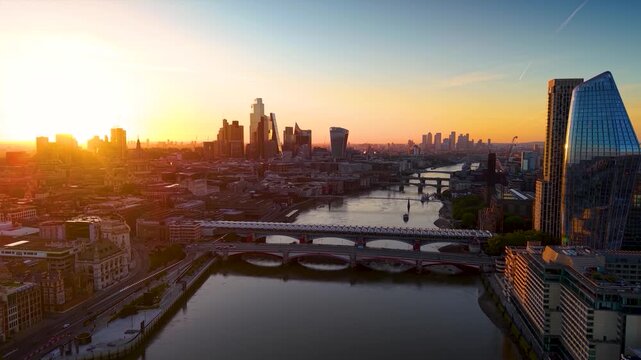 Panoramic aerial sunrise view of the London skyline spanning from the City and St. Pauls Cathedral over to Blackfriars Bridge and Southwark
