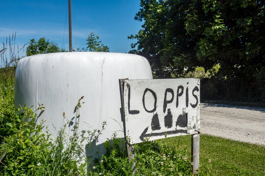 Sandvik, Sweden A hay bale and a sign in Swedish for a rummage sale, Loppis.