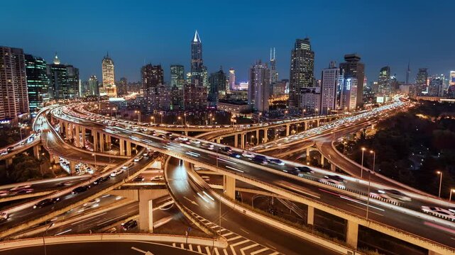 Day to night transition time lapse of busy elevated road intersection with commuters at night, Asia, China, Shanghai	
