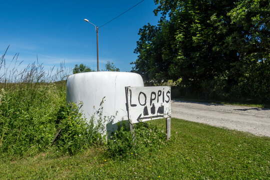 Sandvik, Sweden A hay bale and a sign in Swedish for a rummage sale, Loppis.