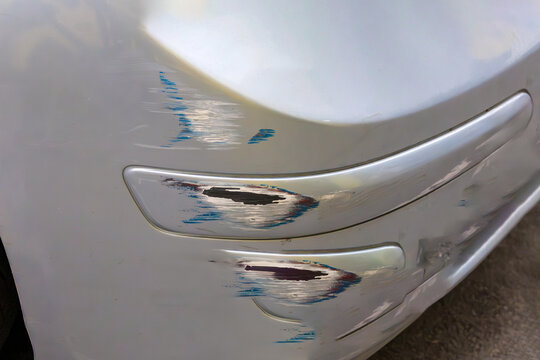 Surface scratches on car bumper damaged on street parking outside